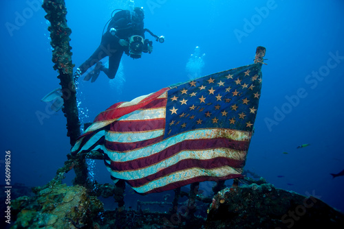 Underwaer videographer surveys American flag flying majestically over the shipwreck of the USCG cutter Duane, Key Largo, Florida photo