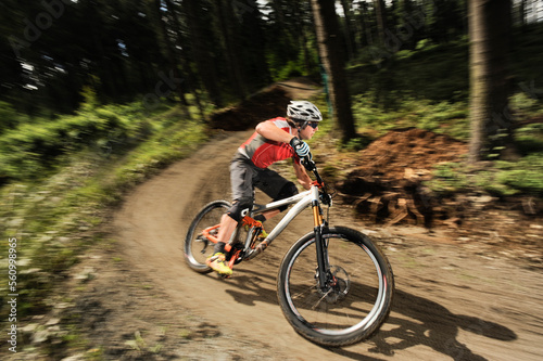 Mountainbiker speeding in forest, Bavaria, Germany photo