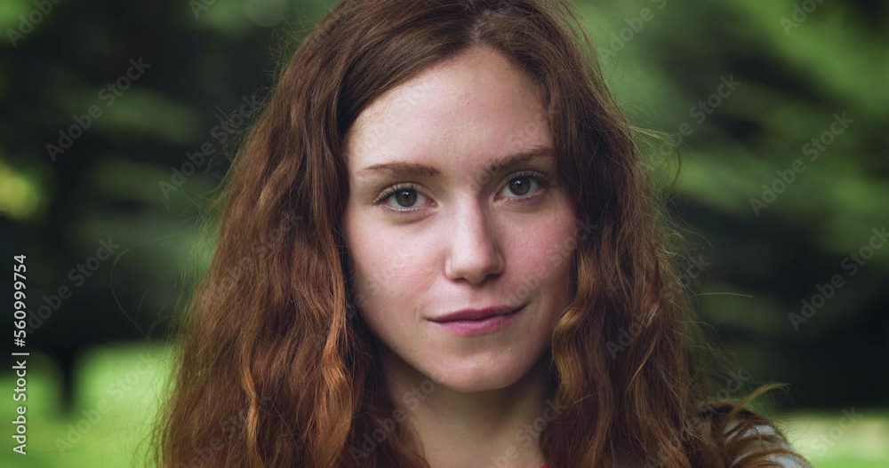 Close up Portrait of a Young Redhead Woman Looking at the Camera in a Green Park During Evening Time. Pretty Teenager with Auburn Hair Enjoying Fresh Air in the Park and Taking Care of her Wellbeing Close up Portrait of a Young Redhead Woman Looking at the Camera in a Green Park During Evening Time. Pretty Teenager with Auburn Hair Enjoying Fresh Air in the Park and Taking Care of her Wellbeing