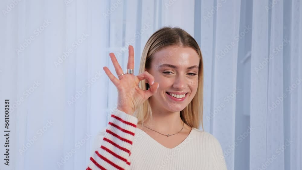 Cheerful young caucasian millennial funny girl smiles at camera showing hand OK sign. Blonde woman shows everything fine success gesture body language, demonstrates symbol of support approval. Cheerful young caucasian millennial funny girl smiles at camera showing hand OK sign. Blonde woman shows everything fine success gesture body language, demonstrates symbol of support approval.