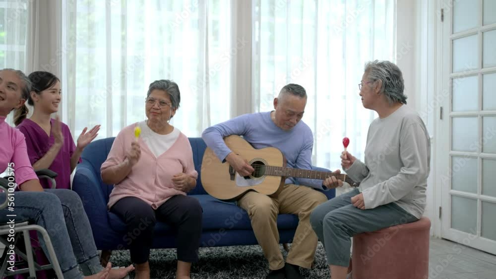 Group of senior peoples enjoy playing guitar and singing together at nursing home