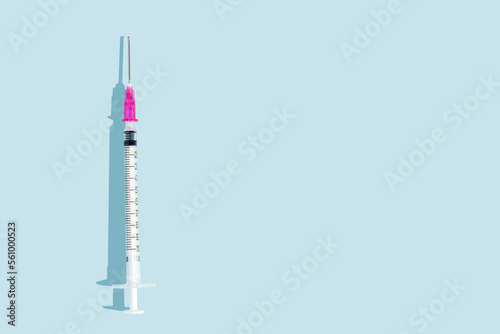medical injection syringe on blue background with.  ample copy space. Syringe for informative poster design. Transparent syringe.