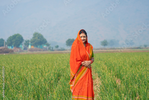 Indian rural woman   s in traditional saree at agriculture field.