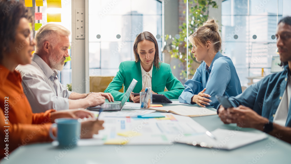 Obraz premium Office Meeting in Conference Room: Diverse Team of Professional Businesspeople Talking about Firm Strategy. Ambitious, Creative Start-up Team Using Laptop and Smartphones, Designing, Planning