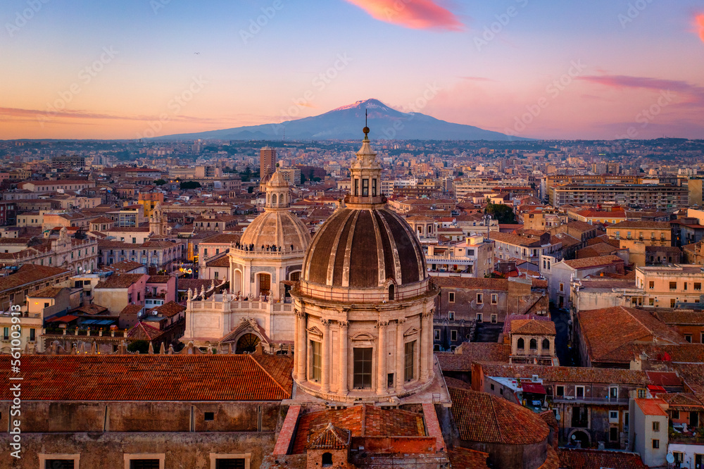 Aerial view of the Catania Saint Agatha's Cathedral by sunset with Mount Etna in the background - Sicily, Italy - obrazy, fototapety, plakaty 