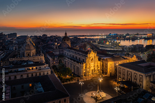 Aerial view of the Catania Saint Agatha's Cathedral by sunrise with Mount Etna in the background - Sicily, Italy
