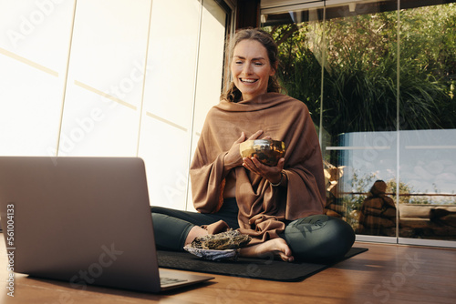 Happy ayurvedic healer streaming a holistic online class at home