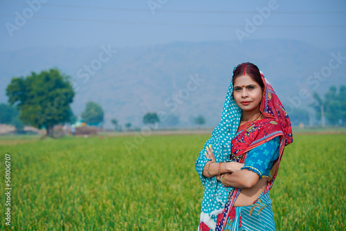 Indian rural woman standing at agriculture field.
