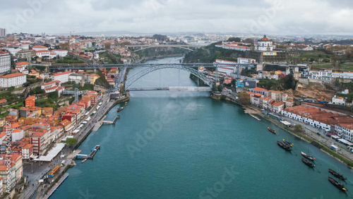 Aerial flying backwards over Douro River revealing Luis I Bridge. Porto, Portugal