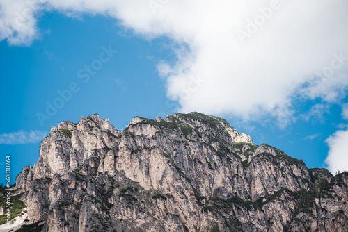 Amazing mountain cliffs viewed from Lago di Dobbiaco - The dolomites - Italy