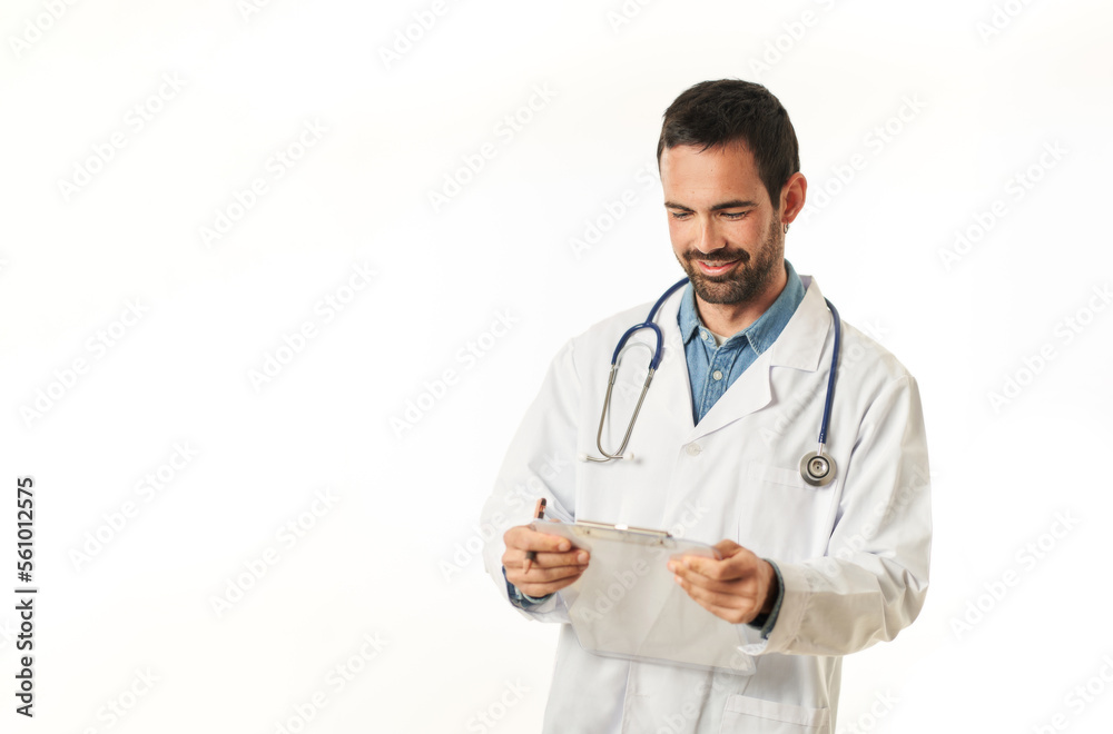 Portrait of a young male doctor with a folder reading a patient's chart, isolated on white background
