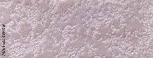 Texture of light pink velvet background from upholstery textile material. Abstract beige velour fabric with pattern