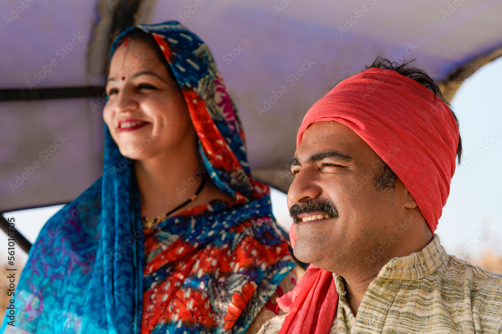 Indian farmer sitting on tractor with wife at agriculture field. Stock ...