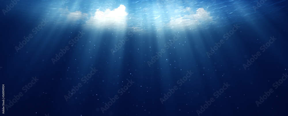 Deep dark blue underwater sea with sun rays and dot particles copy space background.