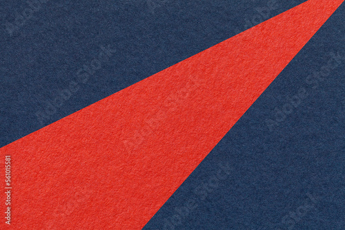 Texture of old craft navy blue and red color paper background, macro. Structure of vintage abstract denim cardboard