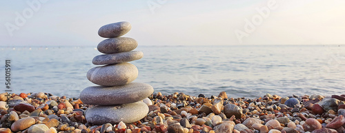 Spa stones balance on the sand of the beach.