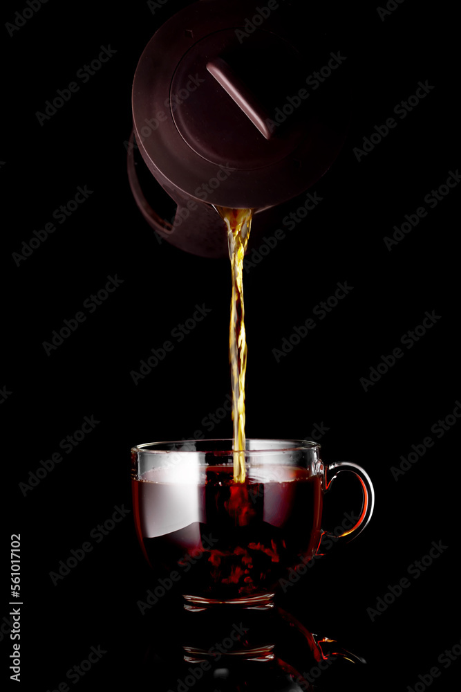 The process of brewing tea, pouring hot water from the kettle into the