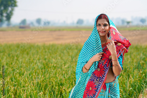 Indian rural woman standing at agriculture field photo