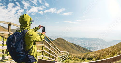man taking photo from the mountain