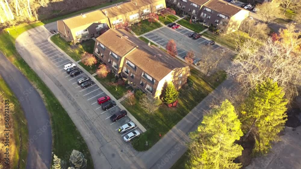 Flying over a large three story barn style house apartment complex with