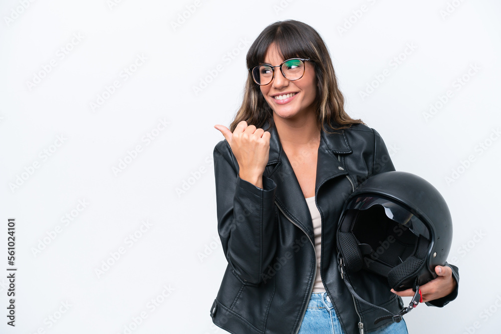 Young caucasian woman with a motorcycle helmet isolated on white background pointing to the side to present a product Young caucasian woman with a motorcycle helmet isolated on white background pointing to the side to present a product