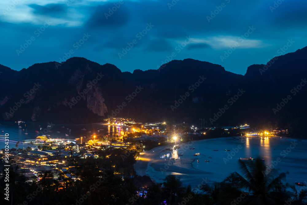 View from above.  View over Ko Phi Phi Don from the viewpoint above the town.  The mountains are in silhouette as night falls and the lights are coming on.