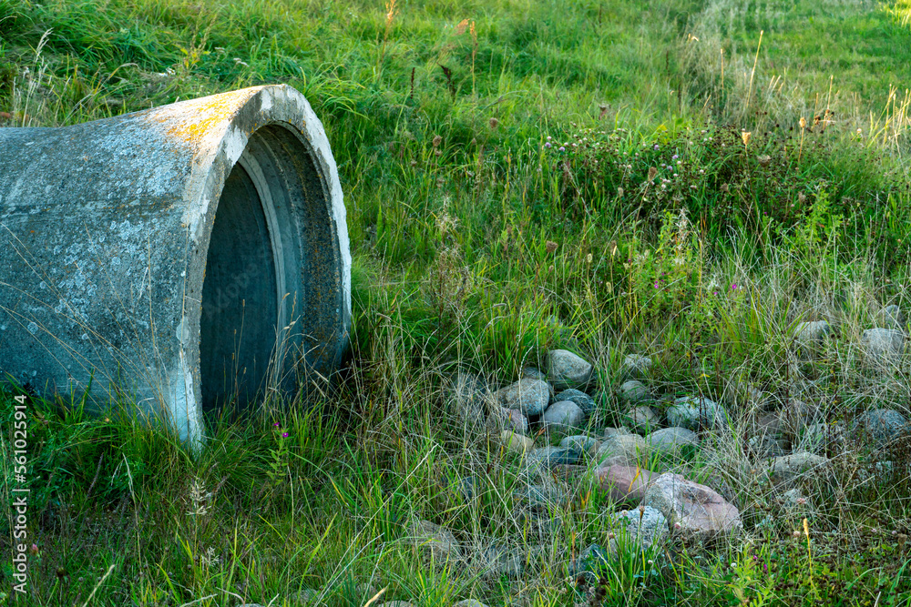 A large concrete pipe for diverting the river under the highway. Leaky dirty water from large concrete pipes. Dirty sewage from the pipe, environmental pollution. Environmental problem A large concrete pipe for diverting the river under the highway. Leaky dirty water from large concrete pipes. Dirty sewage from the pipe, environmental pollution. Environmental problem