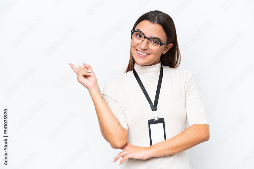 Young caucasian woman with ID card isolated on white background pointing finger to the side