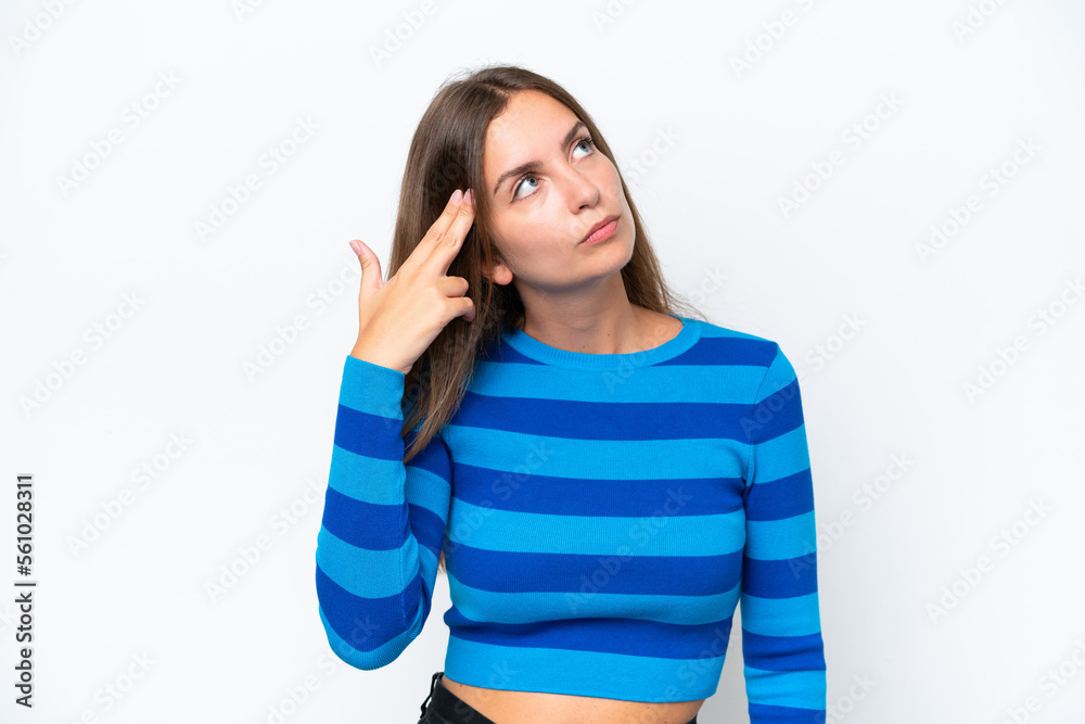 Young caucasian woman isolated on white background with problems making suicide gesture