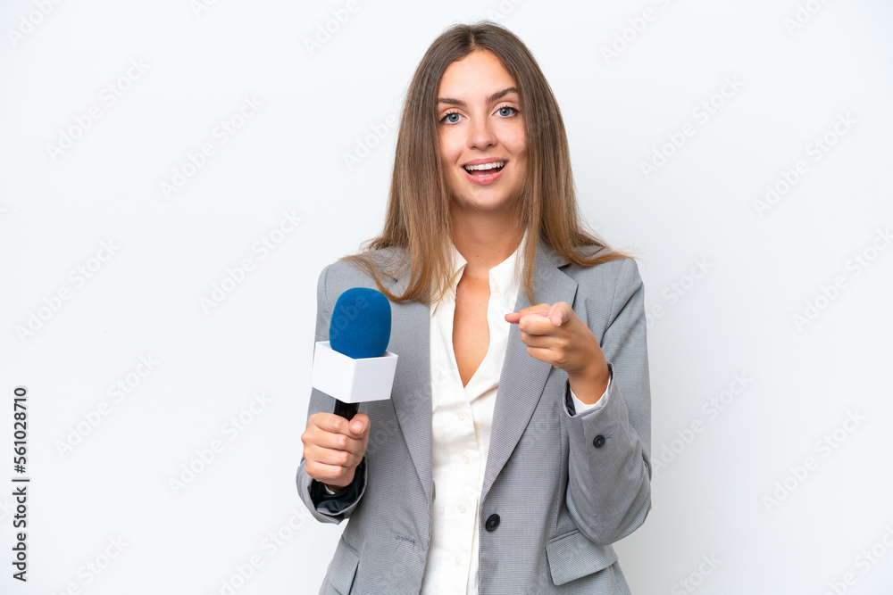 Young TV presenter caucasian woman isolated on white background surprised and pointing front Young TV presenter caucasian woman isolated on white background surprised and pointing front