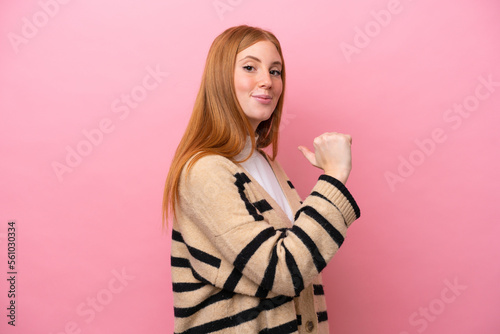 Young redhead woman isolated on pink background proud and self-satisfied