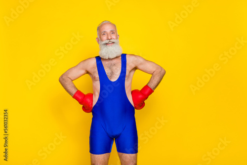 Photo of old age pensioner professional boxer training coach excited positive good mood wear red gloves isolated on bright yellow color background