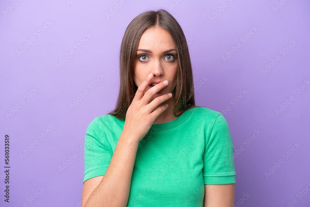 Young caucasian woman isolated on purple background surprised and shocked while looking right Young caucasian woman isolated on purple background surprised and shocked while looking right