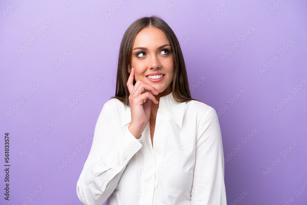 Young caucasian woman isolated on purple background thinking an idea while looking up Young caucasian woman isolated on purple background thinking an idea while looking up