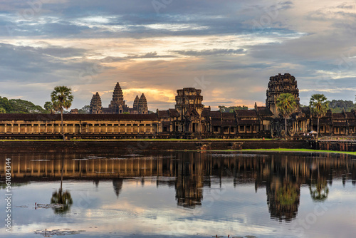 Angkor Wat temple with sunset sky reflecting in water