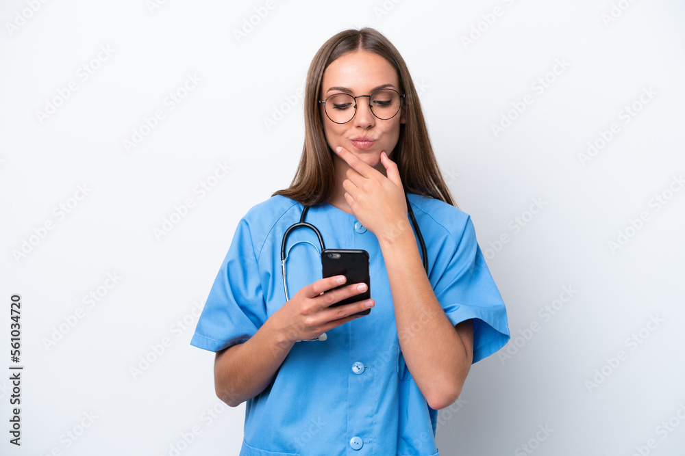 Young nurse caucasian woman isolated on white background thinking and sending a message Young nurse caucasian woman isolated on white background thinking and sending a message