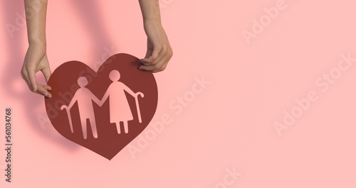 Tableau sur toile Hands holding elderly couple with walking sticks in heart shape, older people me