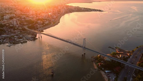 City and Hercilio luz bridge with warm sunset in Florianopolis, Brazil. Drone view photo