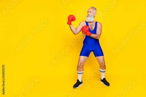 Full length photo old age pensioner wear blue sportswear red gloves battle against abstract opponent empty space funny isolated on yellow color background