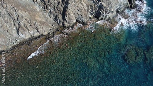 Rocky seashore with stones at the bottom from a drone
