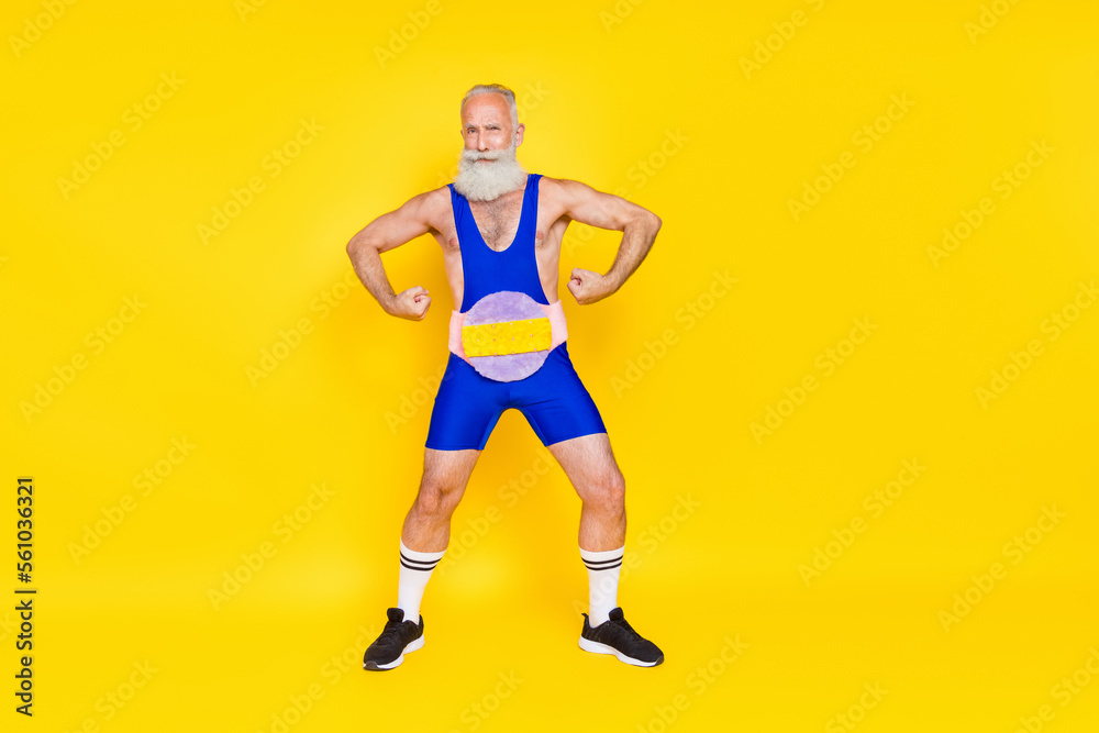 Photo of strong funky retired guy wear blue overall champion belt showing hands muscles isolated yellow color background