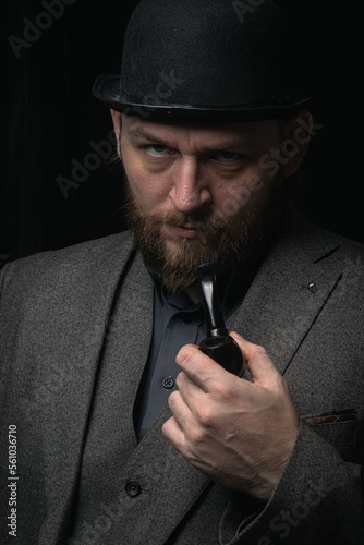 stylish man in retro outfit suit hat smoking wooden pipe sherlock holmes look cosplay england gentleman fashionable confident gangster Guy Ritchie Charlie Hunnam style photo