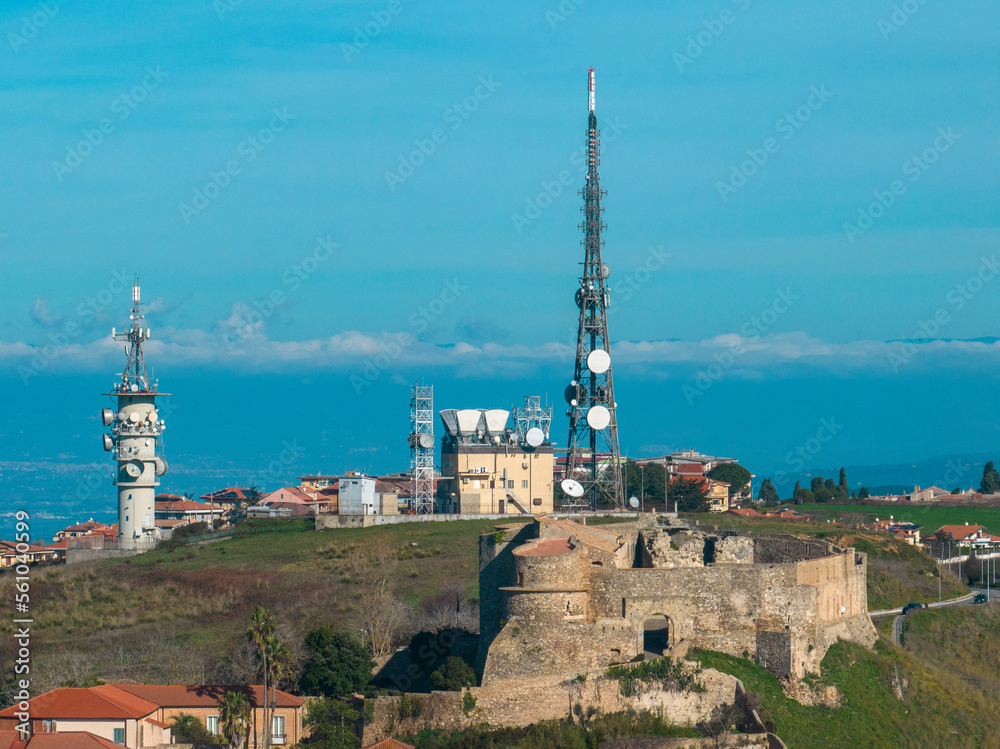 Obraz premium Aerial view of the Norman Swabian castle, Vibo Valentia, Calabria, Italy. Antenna for telecommunications, radio and television transmitting apparatus, electrical and electronic apparatus. 
