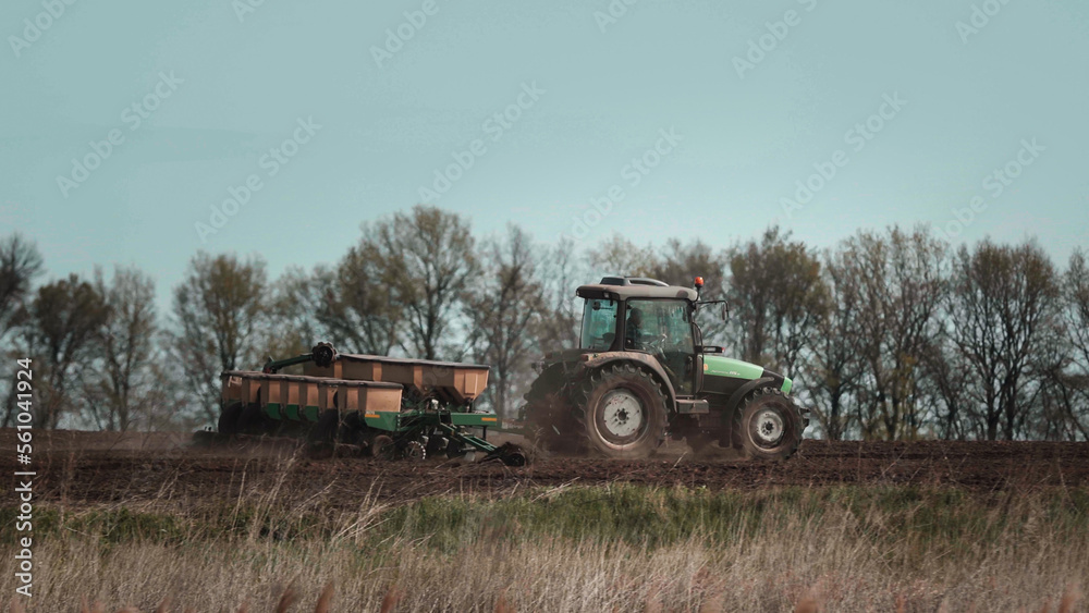 Tractors cultivates the field before seeding Tractors cultivates the field before seeding