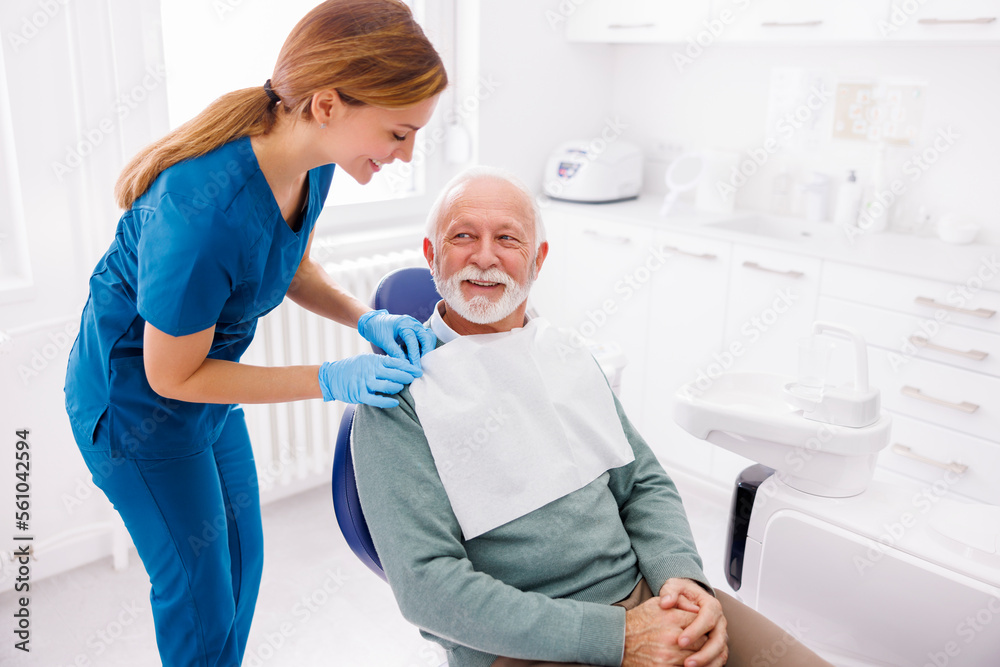 Fototapeta premium Senior man sitting at dental chair waiting for dentist checkup