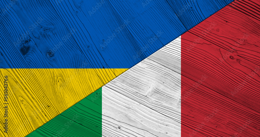 Naklejka premium Background with flag of Ukraine and Italy on wooden split table. 3d illustration