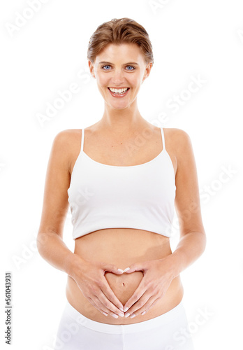 Pregnancy, portrait and mom with a heart on her stomach in a studio for prenatal care, love and happiness. Wellness, health and happy pregnant female model holding her tummy by a white background.