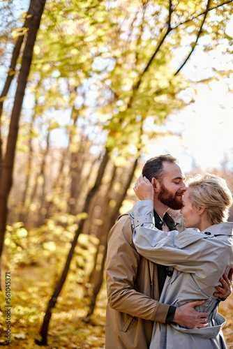 Young caucasian lovers hugging at park. Cute smiling couple in love embracing during date. Lifestyle, people concept. adorable man and woman hugging each other, tenderness between two people