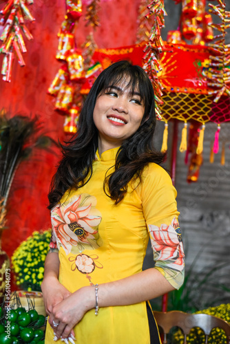 Beautiful Vietnamese woman in traditional vietnamese dress in Tet Lunar New Year