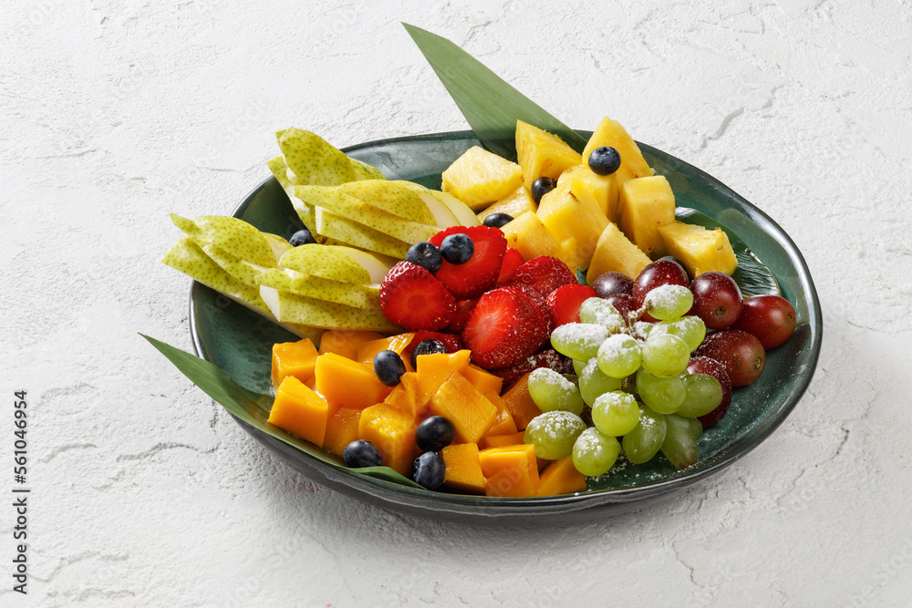 Plate with fresh fruits isolated on white concrete background Plate with fresh fruits isolated on white concrete background